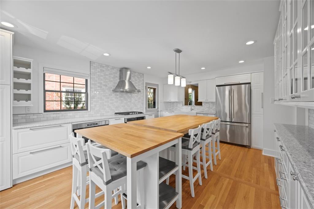 441 Old Farm Road Pittsburgh, PA 15228 - Photo 5 of 33 a kitchen with stainless steel appliances a kitchen island hardwood floor and a sink