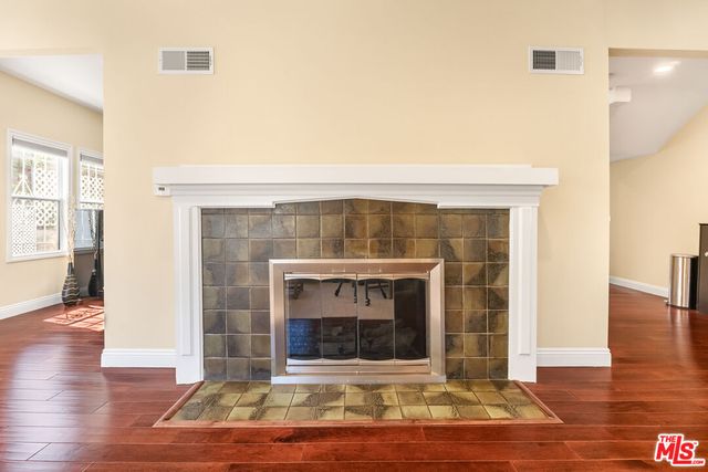 a living room with furniture a fireplace and wooden floor