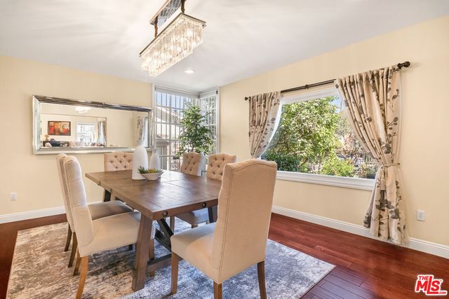 a kitchen with granite countertop a stove a sink and a white cabinets