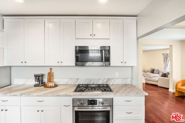 a view of hallway with wooden floor