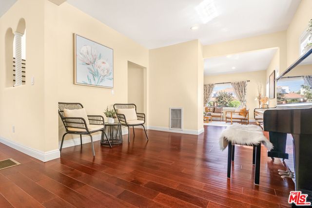 a view of an entryway with wooden floor and pool table and living room