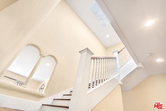 a living room with a bed furniture and a large window