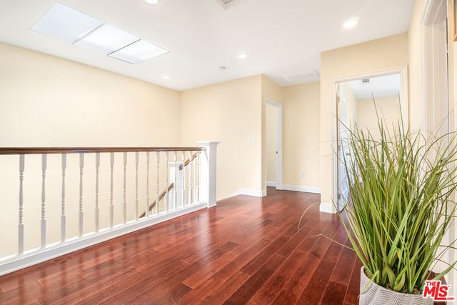 a bathroom with a granite countertop sink a mirror and a bathtub