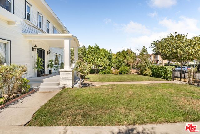 a swimming pool with outdoor seating and yard