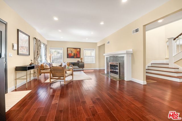 a living room with fireplace furniture and a wooden floor