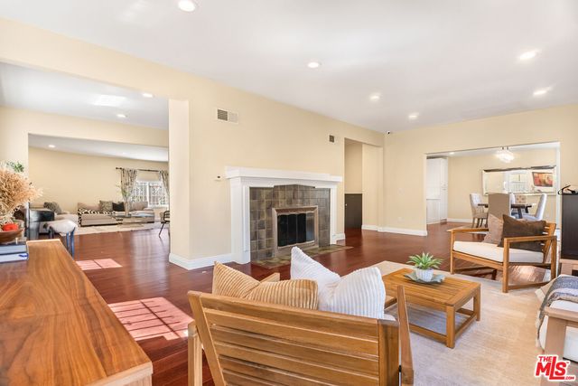a living room with furniture a table and a large window