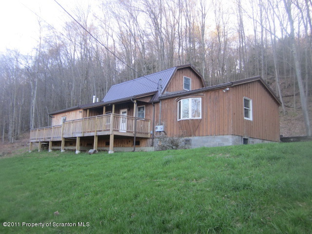2179 Hunsinger Road Hallstead, PA 18822 - Photo 1 of 10 a front view of a house with a garden