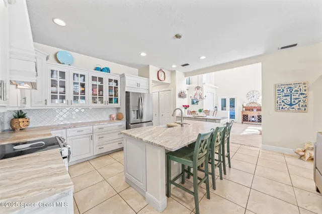 a kitchen with stainless steel appliances kitchen island granite countertop a sink and cabinets