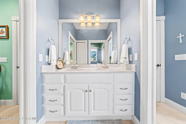 a bathroom with a sink vanity and a mirror