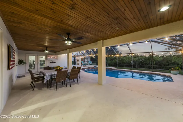 a view of a patio with table and chairs