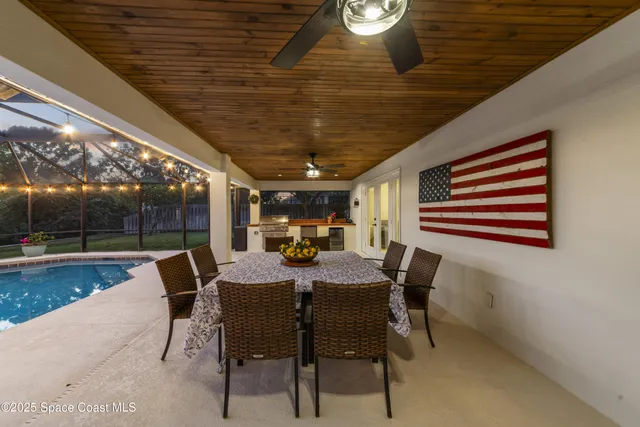 a dining room with furniture and a floor to ceiling window