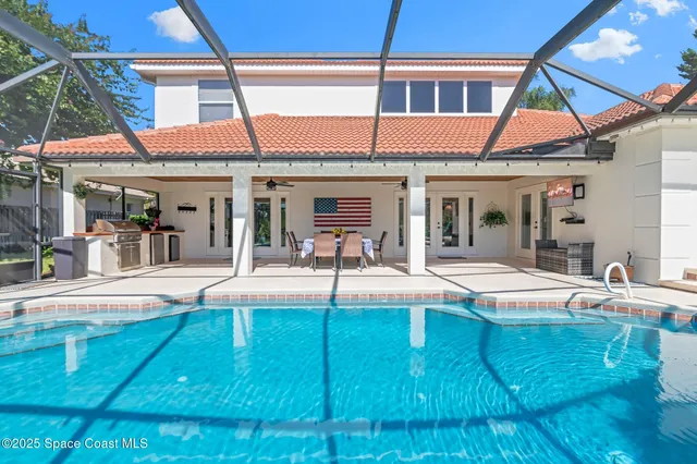 a view of a white building with a swimming pool
