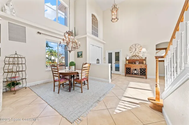 a view of a dining room with furniture and a chandelier