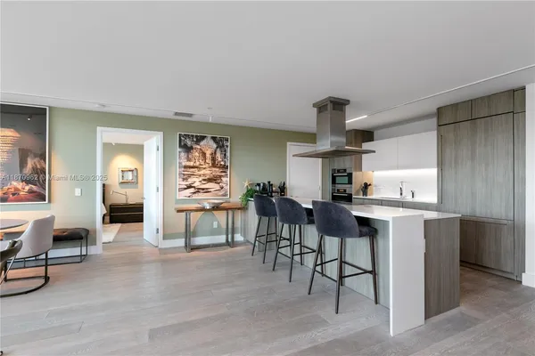 a kitchen with stainless steel appliances granite countertop a stove and cabinets