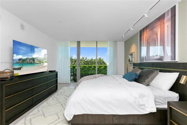 a bedroom with a bed and a large window