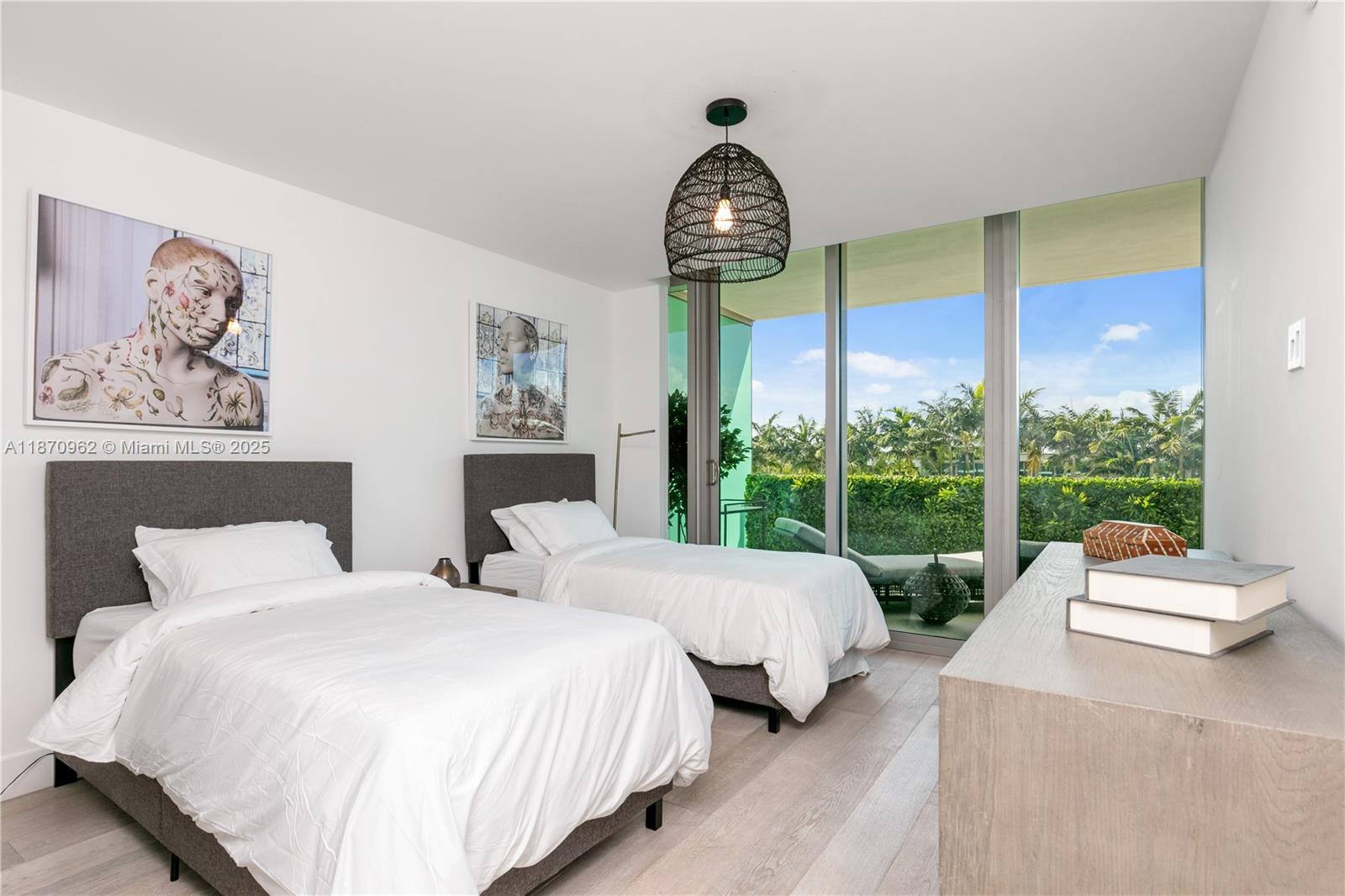 360 Ocean Drive, Unit 305S Key Biscayne, FL 33149 - Photo 20 of 27 a bedroom with two beds and a large window