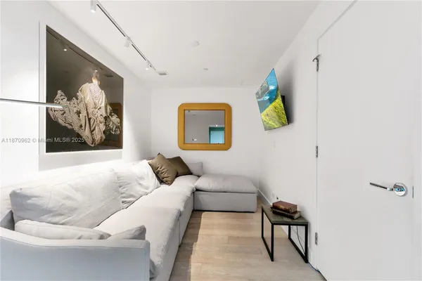 a living room with furniture and wall paintings