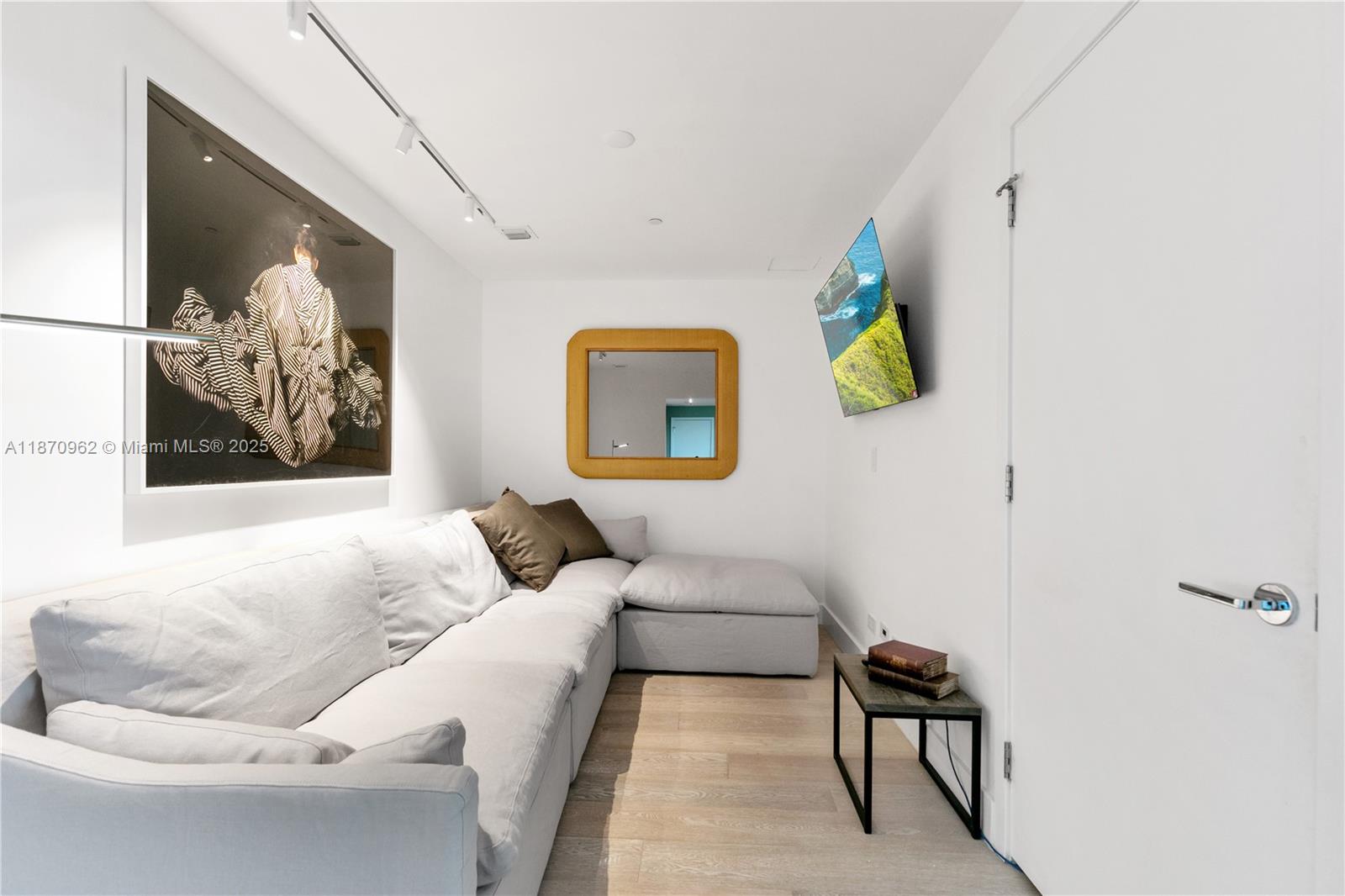 360 Ocean Drive, Unit 305S Key Biscayne, FL 33149 - Photo 22 of 27 a living room with furniture and wall paintings