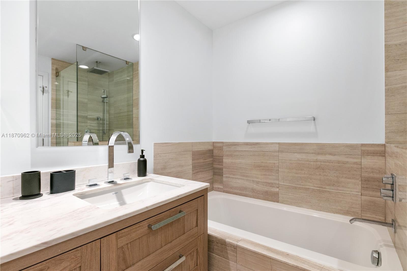 360 Ocean Drive, Unit 305S Key Biscayne, FL 33149 - Photo 24 of 27 a bathroom with a granite countertop sink a toilet and bathtub