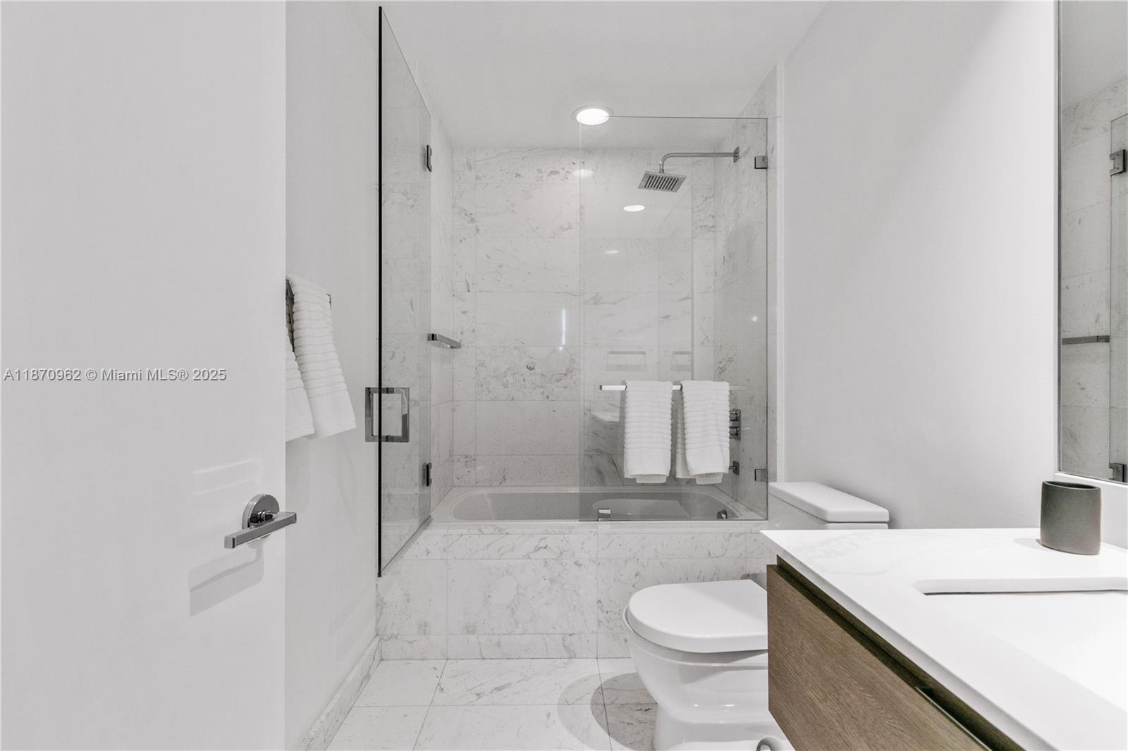 360 Ocean Drive, Unit 305S Key Biscayne, FL 33149 - Photo 27 of 27 a bathroom with a sink a toilet and shower