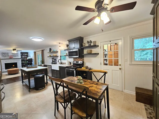 a living room with furniture a window and a flat screen tv