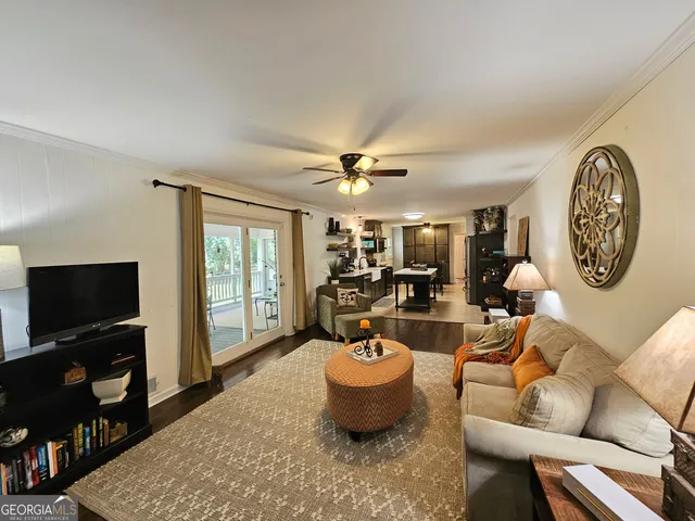 a living room with furniture a clock and a chandelier