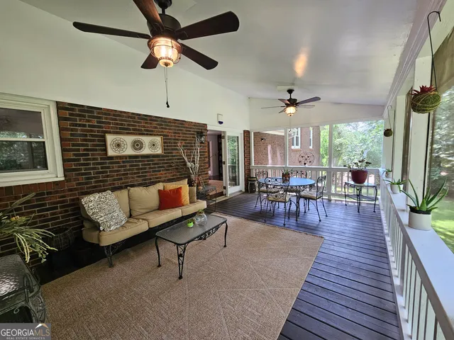 a dining room with furniture a chandelier and wooden floor