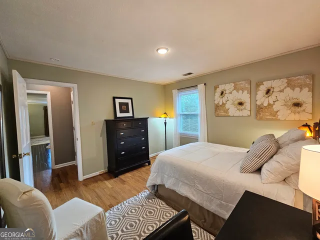 a view of a workspace with furniture and a bookshelf