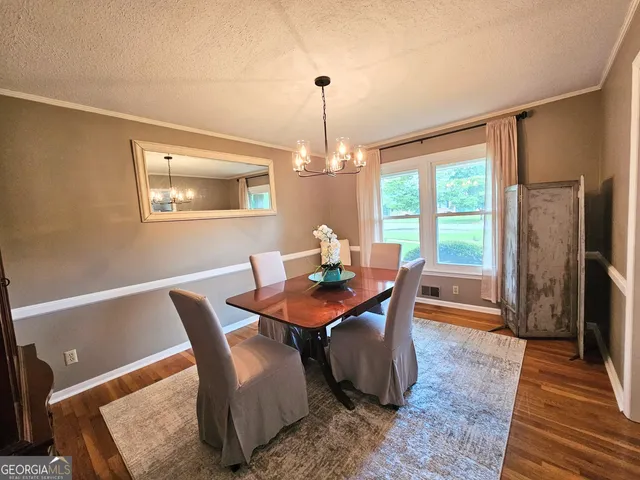 a view of a dining room with furniture window and outside view