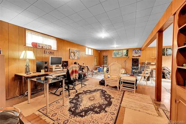 a living room with lots of furniture and a large window