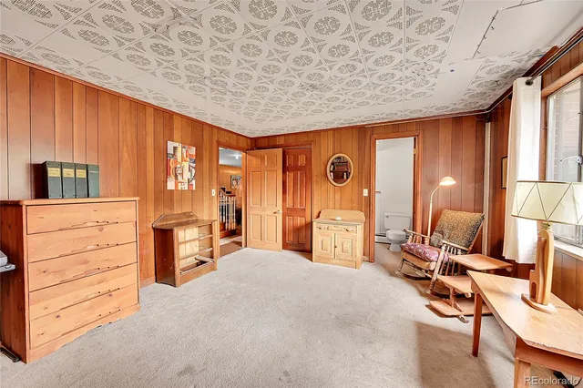 a bedroom with furniture and large windows