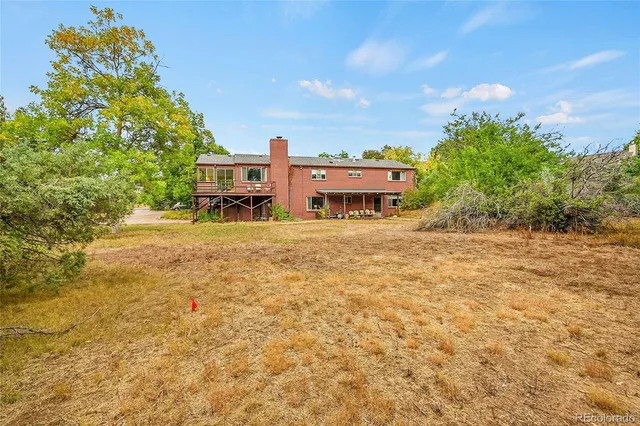 a view of a house with swimming pool and sitting area