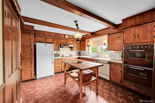a kitchen with stainless steel appliances granite countertop a refrigerator and a stove top oven