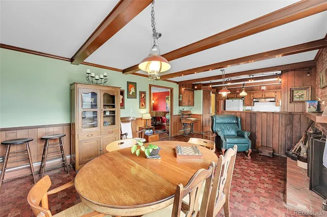a dining room with furniture wooden floor and a rug