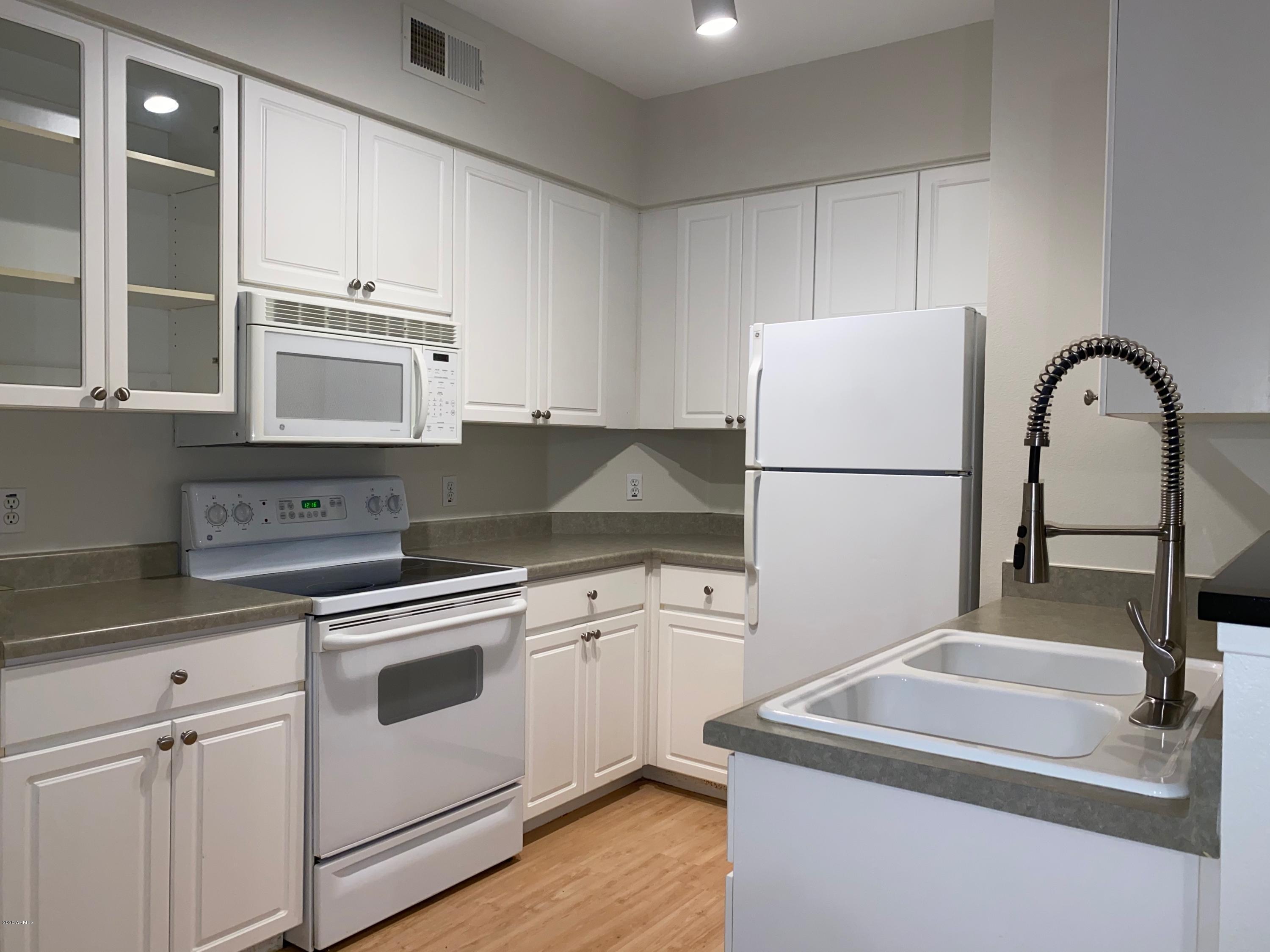 a kitchen with cabinets and stainless steel appliances