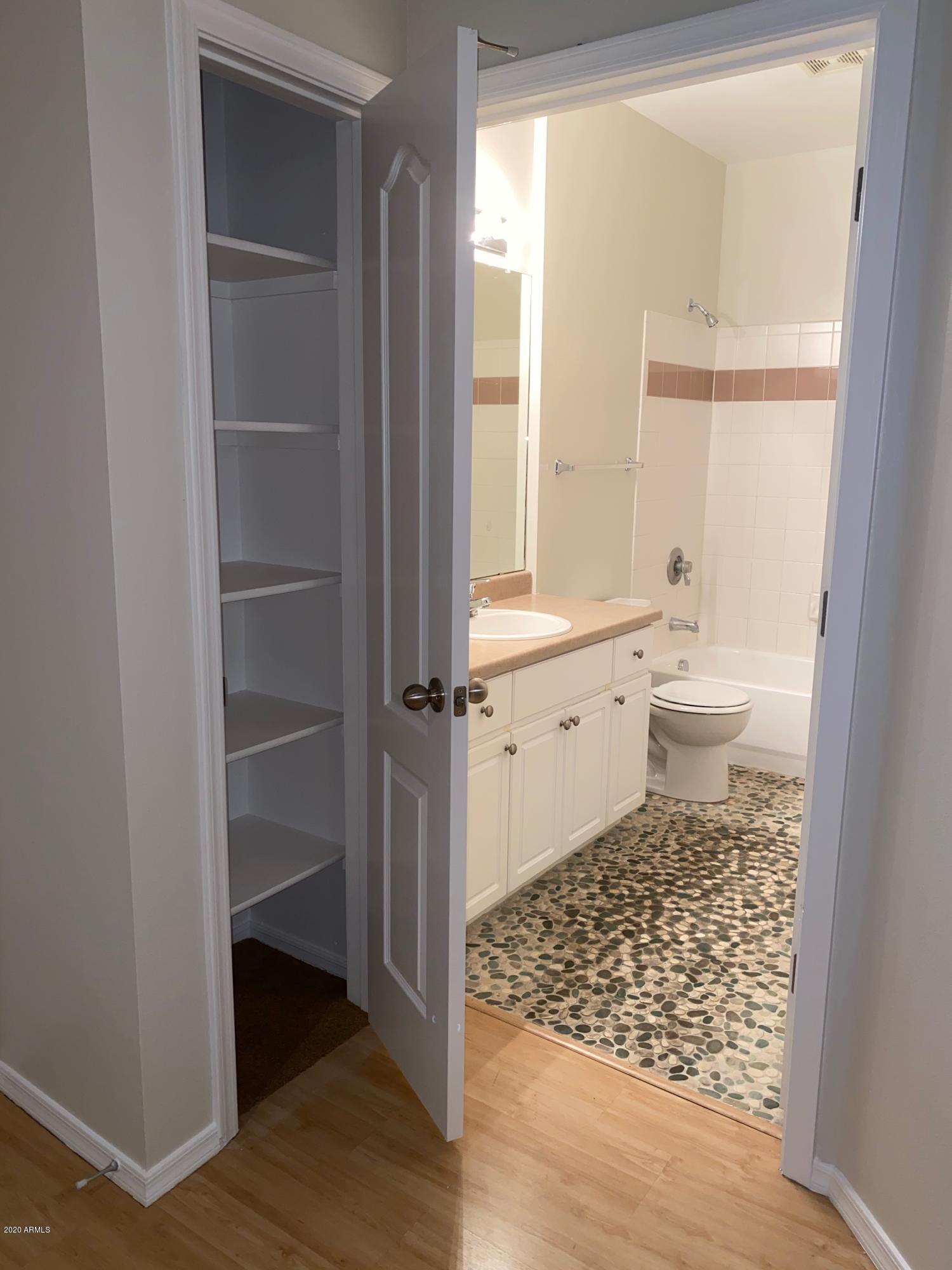 1701 East Colter Street, Unit 263 Phoenix, AZ 85016 - Photo 5 of 18 a bathroom with a toilet a sink and a window
