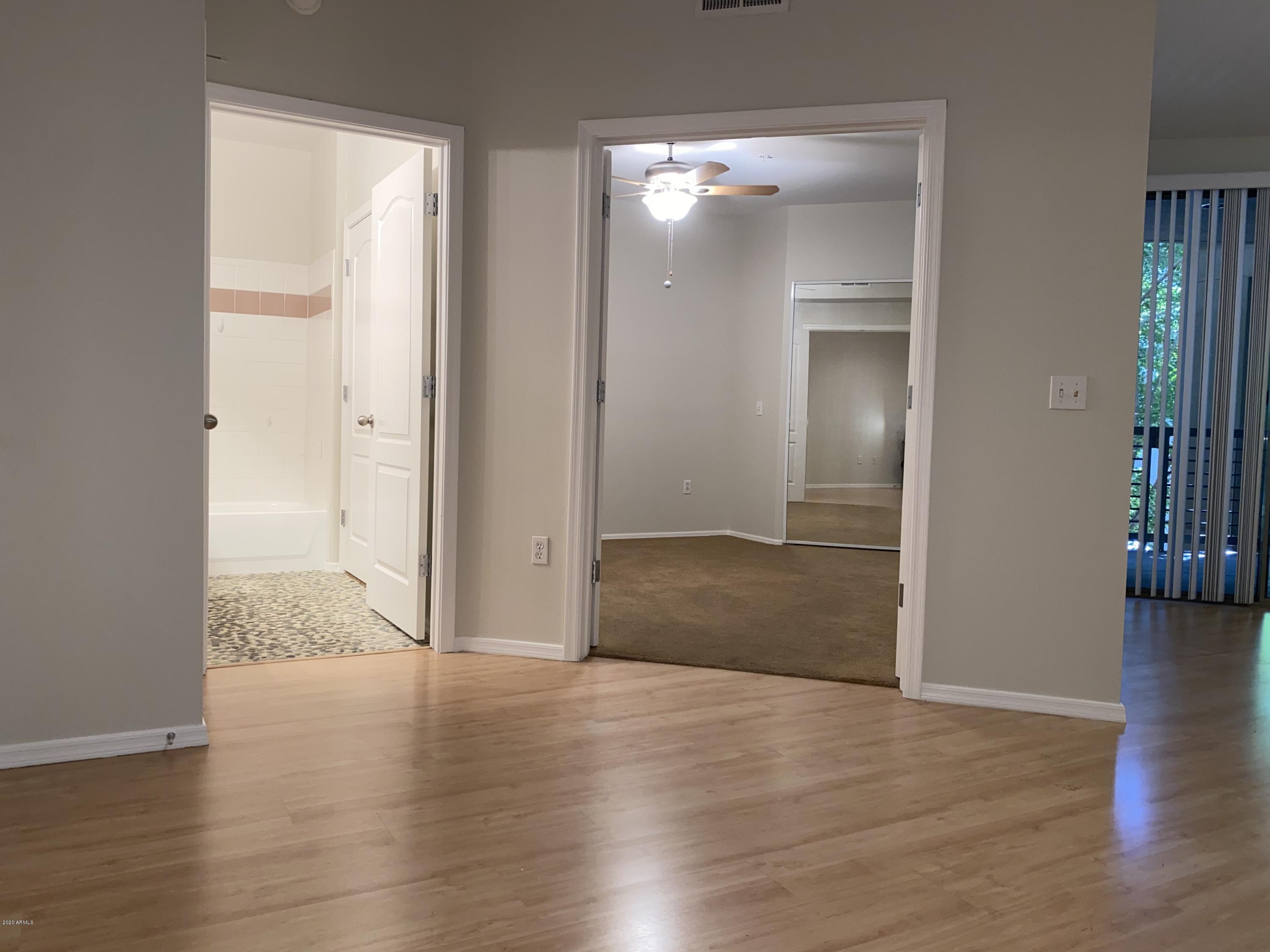 1701 East Colter Street, Unit 263 Phoenix, AZ 85016 - Photo 7 of 18 a view of wooden floor and windows in a room