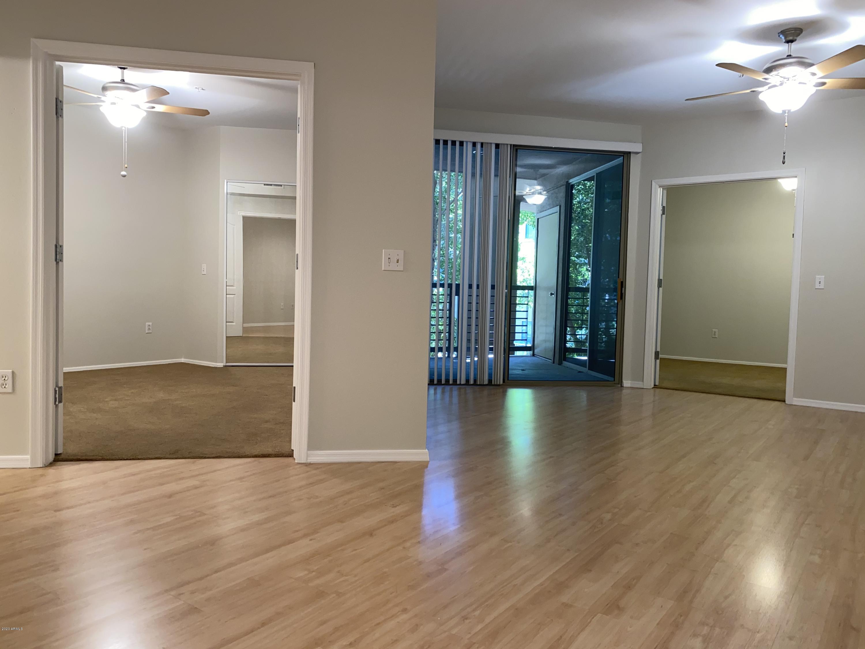 1701 East Colter Street, Unit 263 Phoenix, AZ 85016 - Photo 8 of 18 a view of livingroom with hardwood floor and window