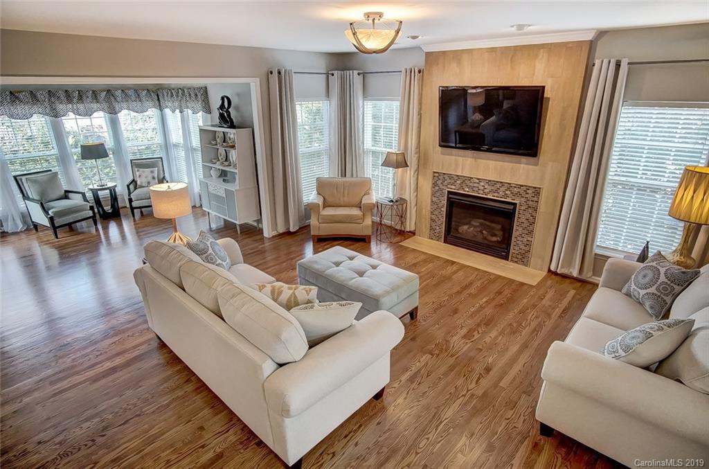 2353 Harvester Avenue Fort Mill, SC 29708 - Photo 3 of 25 a living room with furniture a flat screen tv and a fireplace