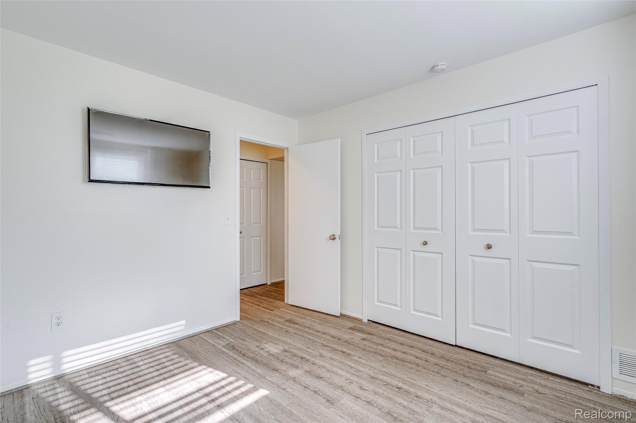 29860 West 12 Mile Road, Unit 604 Farmington, MI 48334 - Photo 18 of 26 Unfurnished bedroom with a closet and light wood-style floors