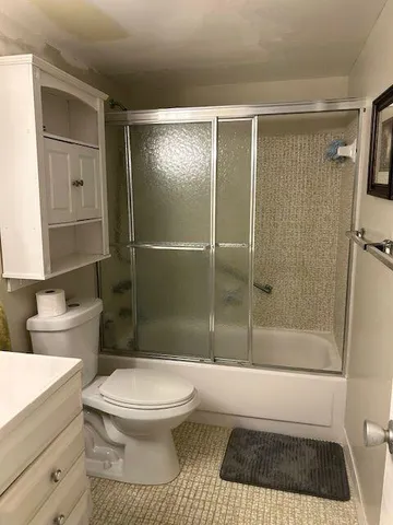 a bedroom with two beds and a painting on the wall