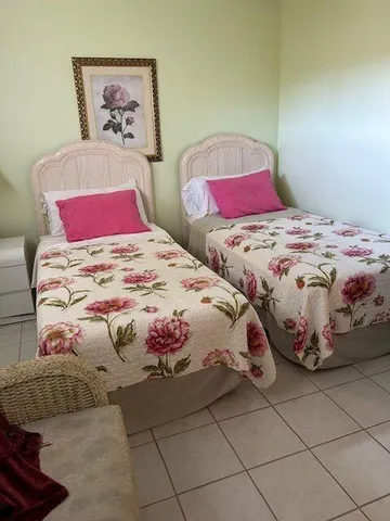 a view of a workspace room with furniture and a window