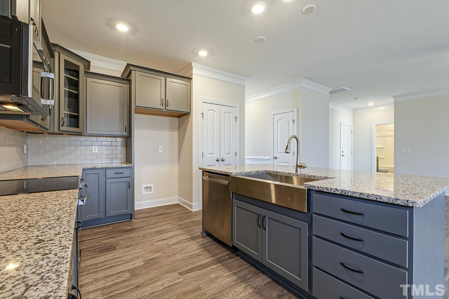 435 Cliffview Drive Garner, NC 27529 - Photo 12 of 45 a large kitchen with stainless steel appliances granite countertop a sink and wooden cabinets