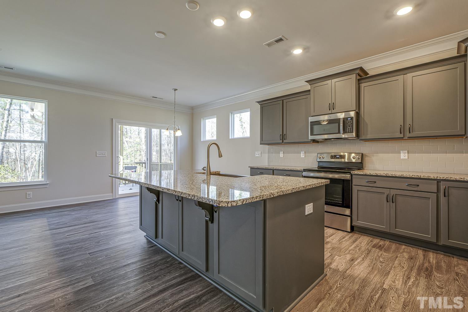 435 Cliffview Drive Garner, NC 27529 - Photo 13 of 45 a kitchen with stainless steel appliances granite countertop a sink stove and cabinets