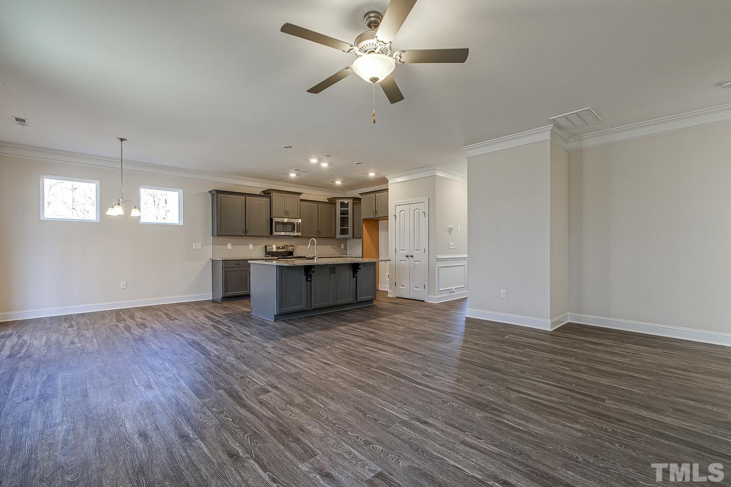 435 Cliffview Drive Garner, NC 27529 - Photo 17 of 45 a view of kitchen and empty room with wooden floor