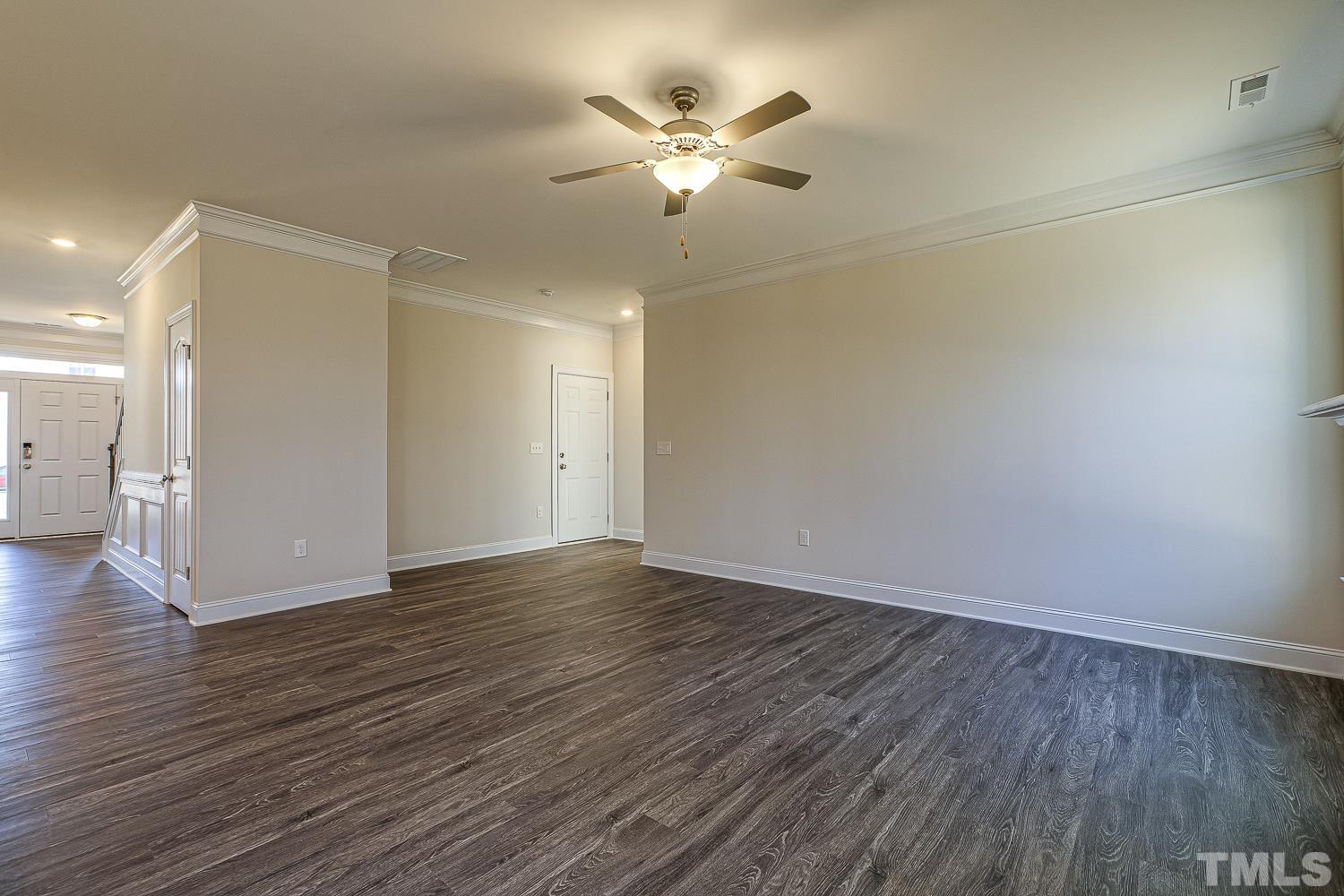 435 Cliffview Drive Garner, NC 27529 - Photo 20 of 45 a view of an empty room with wooden floor and a ceiling fan