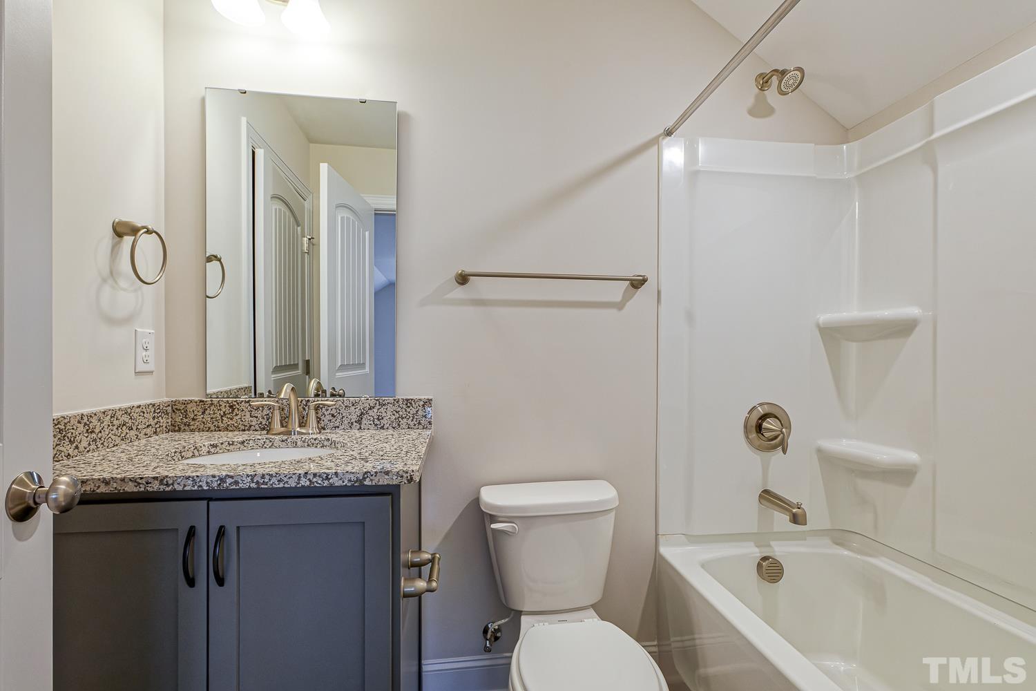 435 Cliffview Drive Garner, NC 27529 - Photo 23 of 45 a bathroom with a granite countertop sink a toilet and shower