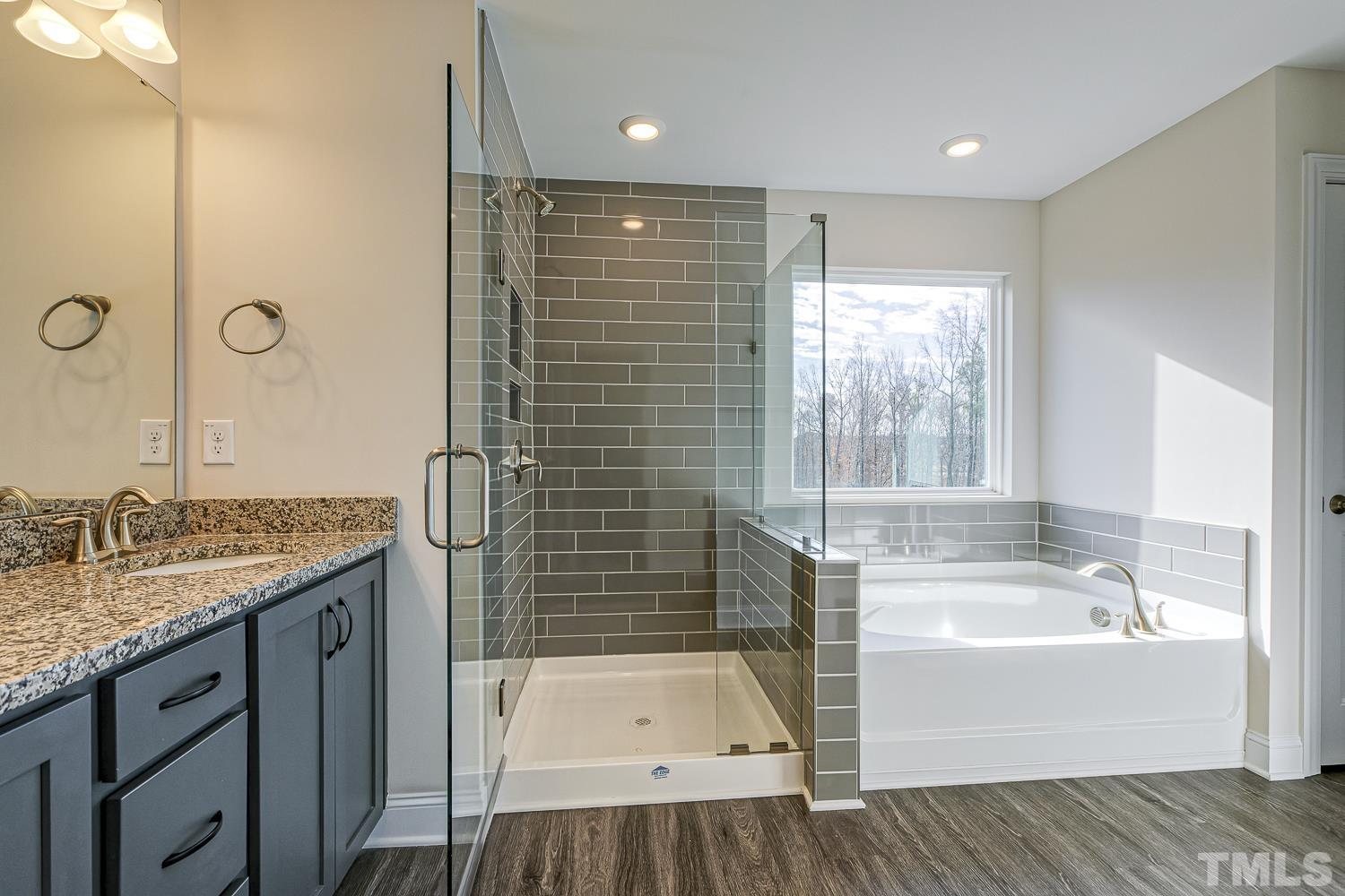 435 Cliffview Drive Garner, NC 27529 - Photo 36 of 45 a bathroom with a granite countertop tub sink and mirror