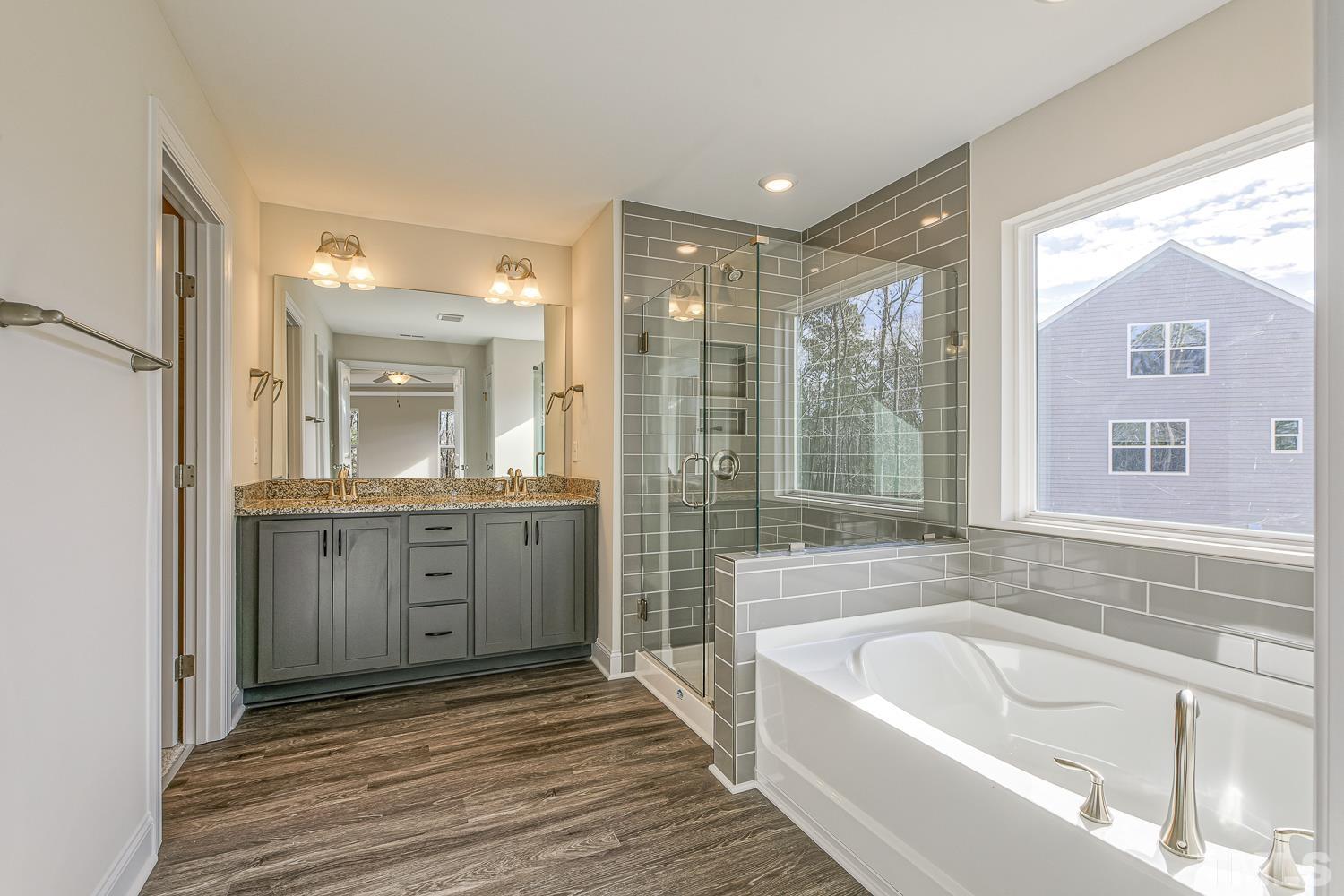 435 Cliffview Drive Garner, NC 27529 - Photo 37 of 45 a bathroom with a granite countertop tub sink shower and mirror