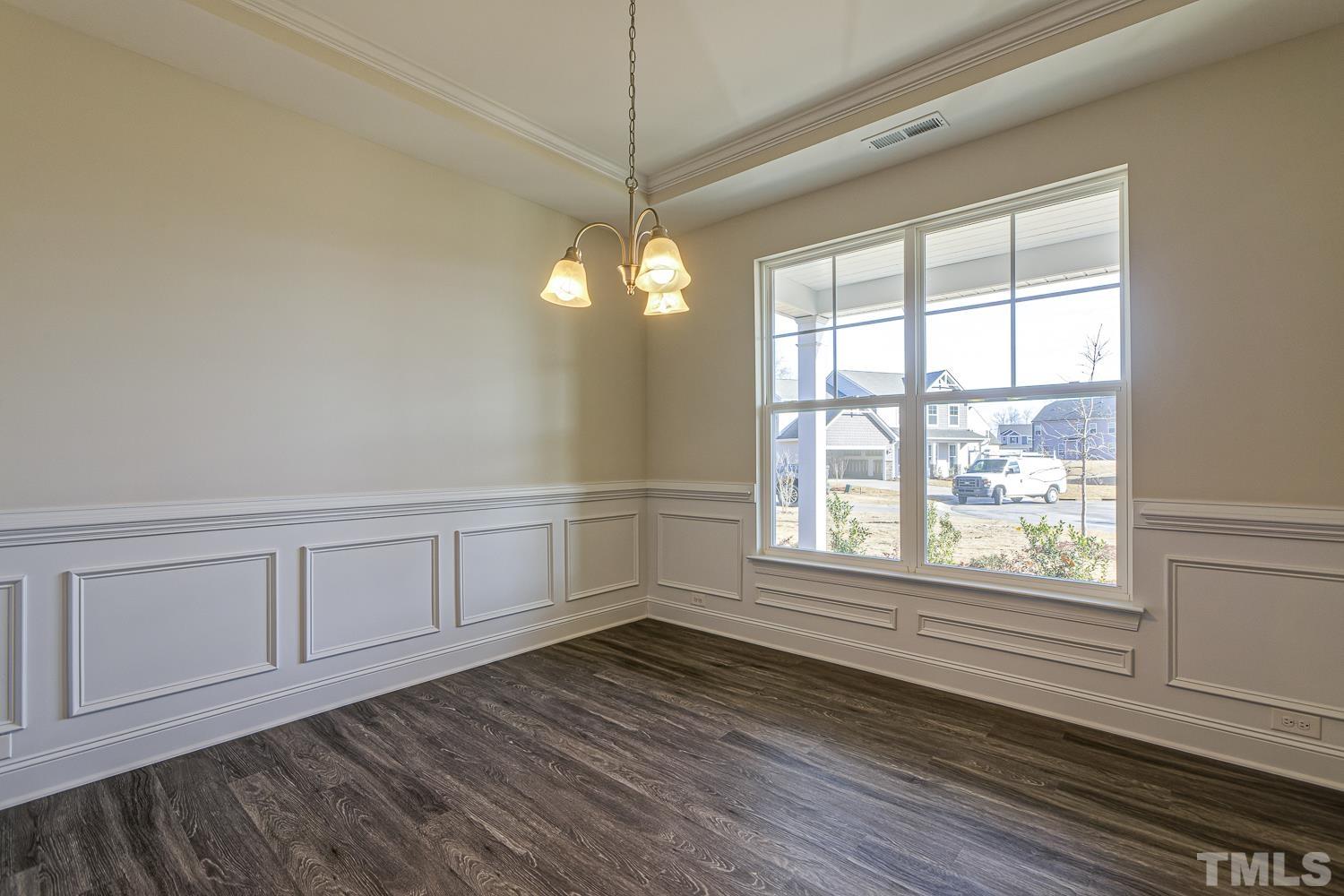 435 Cliffview Drive Garner, NC 27529 - Photo 8 of 45 a view of an empty room with wooden floor and a window